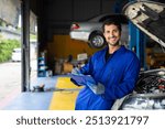 Portrait hispanic latin male mechanic repairs car in garage. Auto car mechanic professional working and checking car engine at garage. Car repair and maintenance