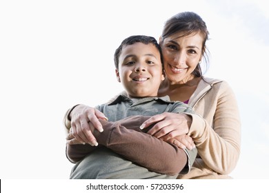 Portrait Of Hispanic Mother And 10 Year Old Son Outdoors