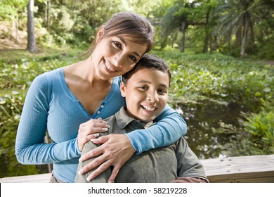 Portrait Of Hispanic Mother And 10 Year Old Son Outdoors In Park