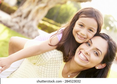 Portrait Of Hispanic Mother And Daughter In Park