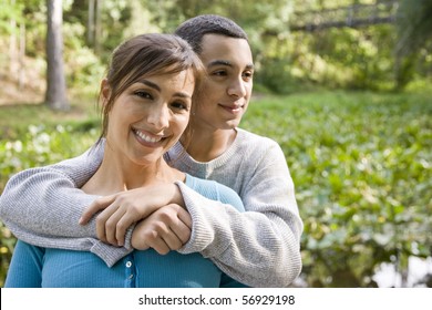 Portrait Of Hispanic Mother And Teenage Son Outdoors In Park