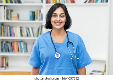 Portrait Of Hispanic Nurse Looking At Camera At Hospital