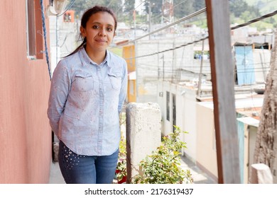 Portrait Of Hispanic Woman In Her House - Young Latin Mother On The Balcony Of Her House - Rural Area In Latin America