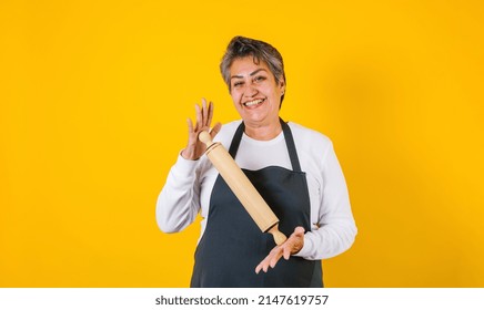 Portrait Of Hispanic Woman Middle Aged Cooking And Holding Mexican Mortar With Sauce Ingredients In Mexico Latin America
