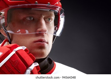 Portrait Of A Hockey Player Against Black Backround