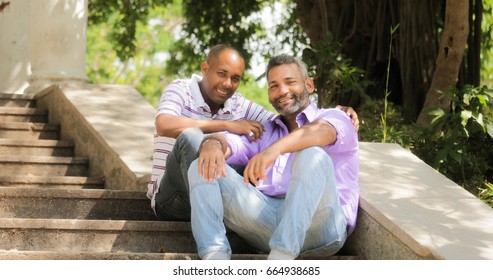 Portrait Of Homosexual Couple Hugging Outdoor And Looking At Camera. Same Sex Marriage Between Hispanic Men.
Two Happy Gay People Smiling And Posing.