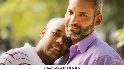 Portrait Of Homosexual Couple Hugging Outdoor And Looking At Camera. Same Sex Marriage Between Hispanic Men.
Two Happy Gay People Smiling And Posing.