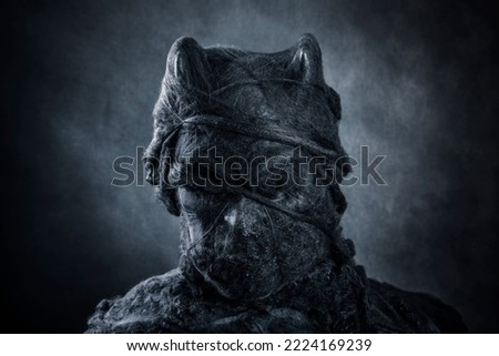 Portrait of a horned demon on dark misty background