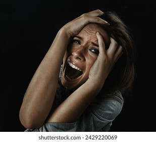 Portrait, horror and fear with woman screaming in studio on black background for reaction to danger. Face, stress and mental health with scared young person in dark for phobia, nightmare or terror - Powered by Shutterstock