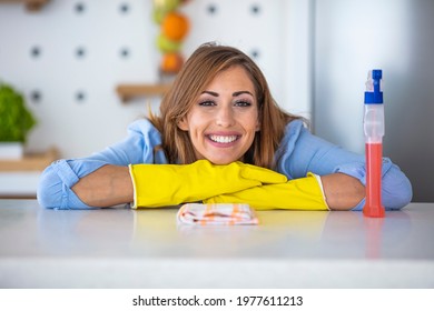 Portrait Of A Housekeeper Holding Cleaning Products While Working At Home And Looking At The Camera Smiling. People, Housework And Housekeeping Concept