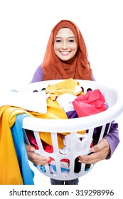 Portrait Of Housewife Wearing Hijab Carrying Laundry Basket Full Of Dirty Clothes Isolated On White Background