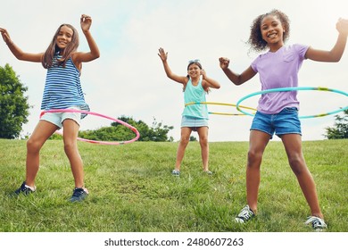 Portrait, hula hoop and children in park, girls and happiness with fun, bonding together and playful. Leisure, outdoor or friends with recreation, game or cheerful with weekend break, summer or smile - Powered by Shutterstock