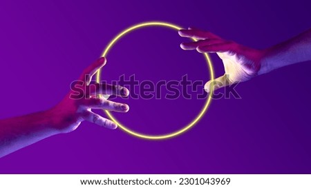 Portrait with human hands holding neon, glowing round, sphere over abstract minimal purple background in neon light. Concept of geometric figures, ultraviolet light, virtual reality, technologies, ad
