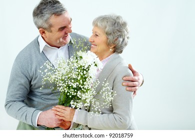 Portrait Of Husband Giving Bouquet Of Flowers To Wife At Woman?s Day