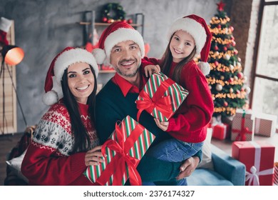 Portrait of idyllic friendly family parents hold hands cute daughter newyear giftbox festive decor house indoors
