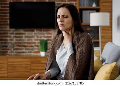 Portrait of ill young woman at home having cough and sore throat. First symptoms of cold and flu virus, pneumonia, bronchitis and respiratory tract infection. Seasonal virus disease