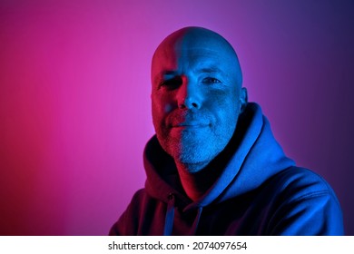 Portrait Illuminated Of Neon Lighting. Successful And Determined Middle Aged Man. 
