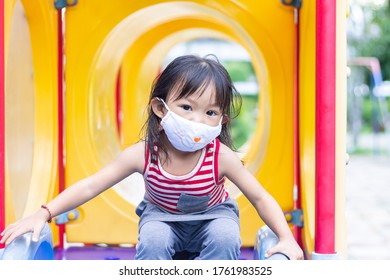 Portrait Image Of 2-3 Yeas Old Baby. Happy Asian Child Girl Smiling And Wearing Fabric Mask,​ She Playing With Slider Bar Toy At The Playground, Social​ Distance,​ Learning And Active Of Kids Concept.