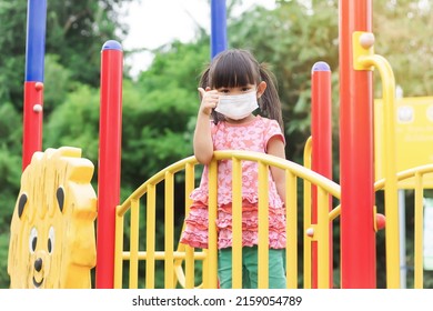 Portrait Image Of 4-5 Yeas Old Baby. Happy Asian Child Girl Smiling And Wearing Face Mask,​ She Showing The Thumb Up Fingers Social​ Distance,​ Learning And Active Of Kids Concept.