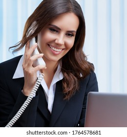 Portrait Image Of Businesswomen Or Customer Support Female Phone Operator Or Sales Agent In Confident Suit, With Phone And Laptop At Office. Assistance Service Call Center, Zoom Conference Consulting.