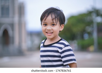 Portrait image of cute little kid looking at camera and smiling