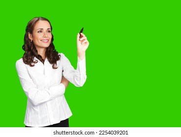 Portrait image of happy smiling beautiful businesswoman in white confident cloth, writing or drawing on screen with marker. Brunette business woman. Green chroma key background. - Powered by Shutterstock