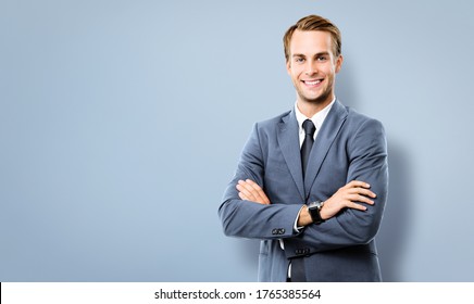 Portrait image of happy smiling confident businessman in grey suit, standing in crossed arm pose, against grey background with copy space for some text. Business success concept picture.
Corporate man - Shutterstock ID 1765385564