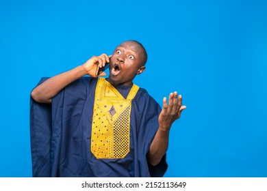 portrait image of a traditional black man wowed while receiving phone call - Shutterstock ID 2152113649