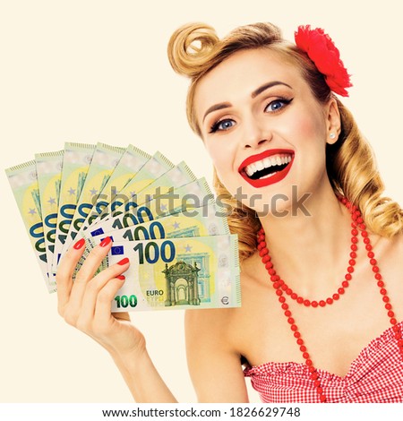 Portrait image of very happy, excited pinup beautiful woman holding money euro cash banknotes, pin up style. Blond girl in retro and vintage studio concept. Square.