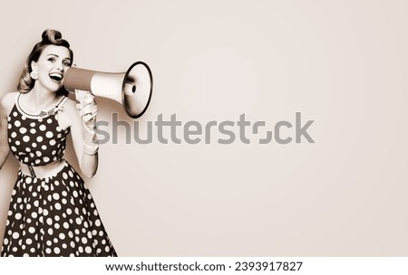 Portrait image of yelling woman holding mega phone megaphone, shout advertising promo offer. Girl in wear pin up style dress with loudspeaker. Beauty model. Brown toned black and white bw photo