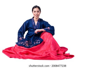 Portrait images of Asian attractive woman wearing a traditional Hanbok, which is a Korean national costume, sitting and smile, On white isolated background, to people and Korean woman concept.
