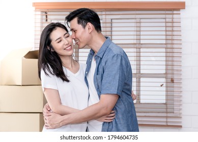 Portrait images of Asian couple , They show love with a kiss on the cheek, because of the joy of moving to a new home together relocation, to people and family concept.