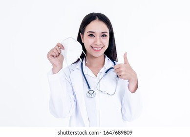 Portrait Images Of Asian Woman Doctor Holding A Mask And Use Her Hand To Make A Great Symbol, Concept To Health Care And Primary Disease Prevention, Such As PM 2.5 And Coronavirus