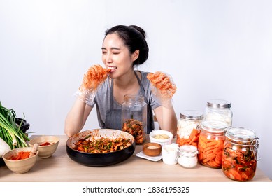 Portrait images of Korean attractive woman is eating Kimchi which she making,  Kimchi which is a fermentation food preservation of Korean people consisting of many fresh vegetables and fruits - Shutterstock ID 1836195325