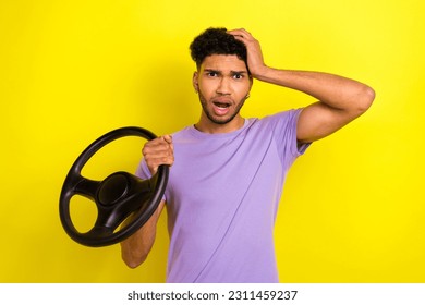 Portrait of impressed confused man arm touch head hold wheel stupor staring isolated on yellow color background - Shutterstock ID 2311459237