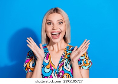 Portrait of impressed crazy girl wear stylish shirt astonished staring at unbelievable discount isolated on vivid blue color background