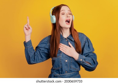 Portrait Of Independent Lady Wear Earphones Listen Music Close Eyes Sing Song On Yellow Background