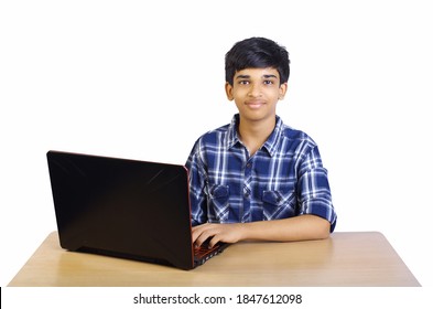 Portrait Of Indian Boy Using Laptop While Attending The Online Class