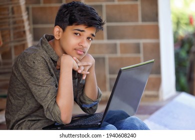 Portrait of Indian boy using laptop while attending the online classes at home	

