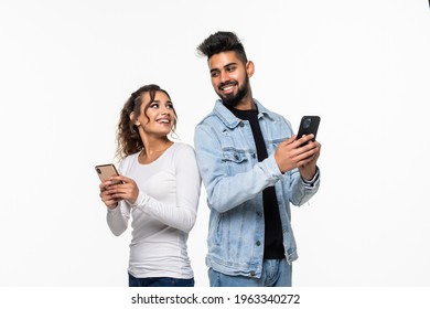 Portrait Of Indian Couple Holding In Phone, Girl Worrying Looking At Guy's Chat Isolated Over White Background