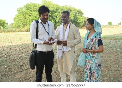 Portrait  of an Indian family at agriculture field with real estate agent - Shutterstock ID 2175522997