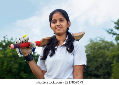 Portrait Of A Indian Female Cricketer Holding A Cricket Bat