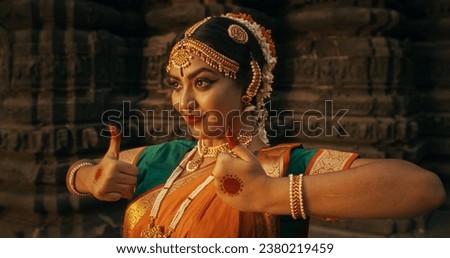 Portrait of an Indian Female Dancer Displaying Symbolic Gesture with Expressive Face, Using Folkloric Dance to Tell a Story. Girl in Traditional Sari Showcasing the Art of Mudras Movement