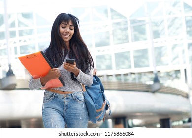 Portrait Of Indian Female University Student Walking In The City With Mobile Phone