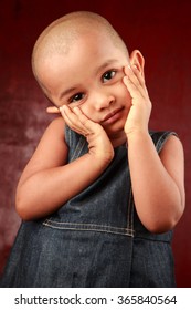 Portrait Of An Indian Girl Child With Shaved Head