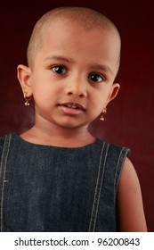 Portrait Of An Indian Girl Child With Shaved Head