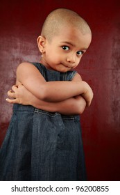 Portrait Of An Indian Girl Child With Shaved Head