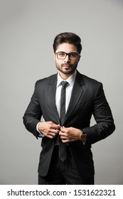 Portrait Of Indian Male Businessman Standing Over White Background