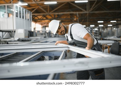 Portrait Indian male staff worker engineer supervisor in safety suit work in factory warehouse. - Powered by Shutterstock