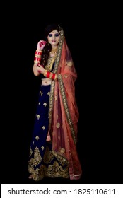 Portrait Of An Indian Muslim Bride Wearing Red Sari With Heavy Jewelry In A Banquet Hall. Traditional Muslim Bride In Wedding.